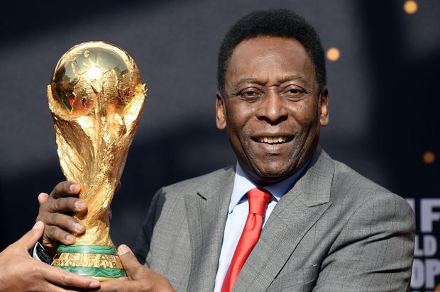 La leyenda del fútbol brasileño Pelé posa con el trofeo de la Copa Mundial de la FIFA el 9 de marzo de 2014 en París. (Foto: AFP)