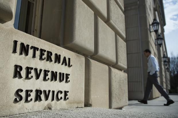 A man enters the Internal Revenue Service building in Washington, DC (Photo by Andrew Caballero-Reynolds / AFP)