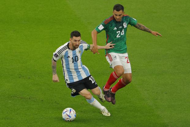 Argentina's forward #10 Lionel Messi (L) fights for the ball with Mexico's midfielder #24 Luis Chavez (R) during the Qatar 2022 World Cup Group C football match between Argentina and Mexico at the Lusail Stadium in Lusail, north of Doha on November 26, 2022. (Photo by Odd ANDERSEN / AFP)