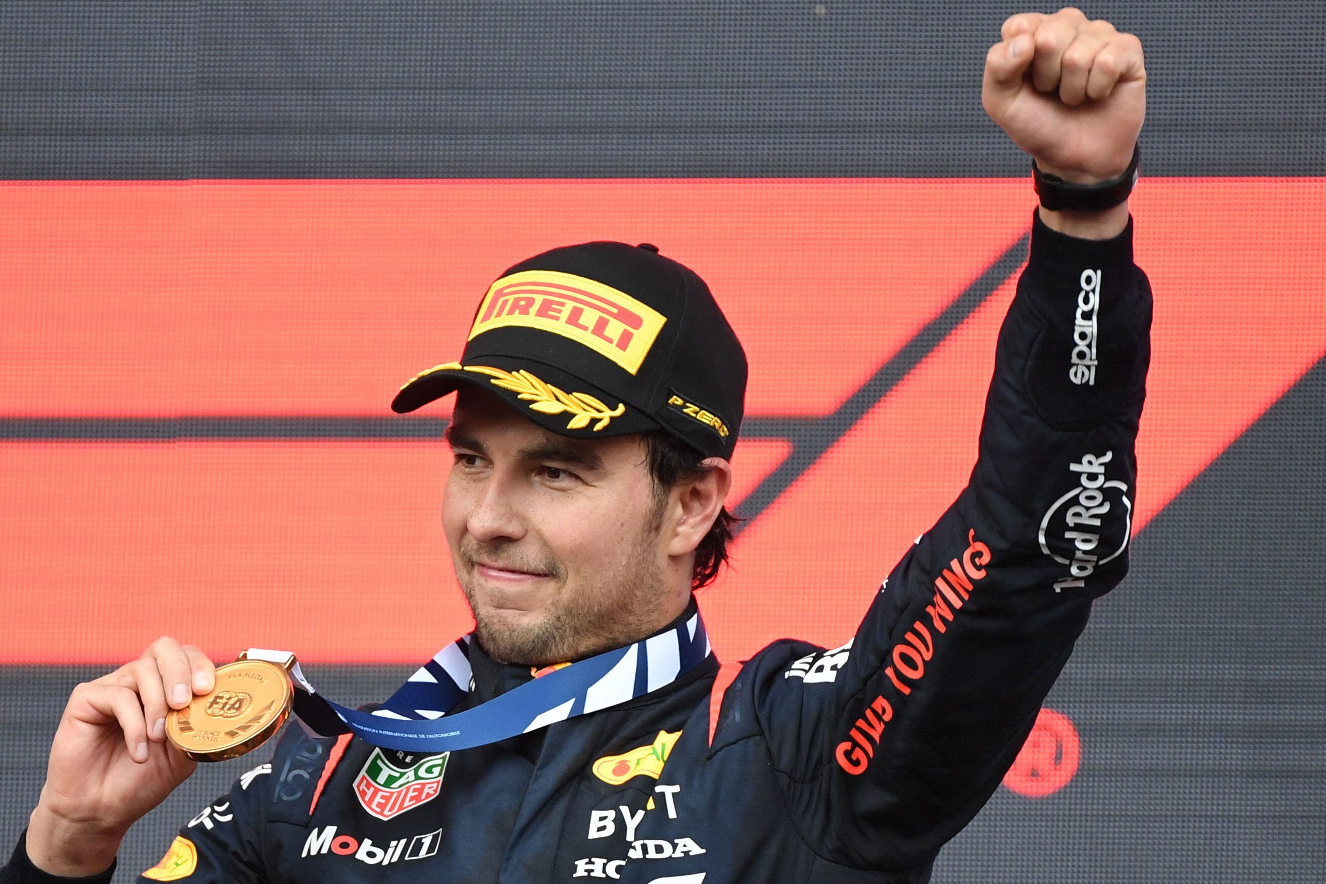 Red Bull Racing's Mexican driver Sergio Perez celebrates on the podium after winning the Formula One Azerbaijan Grand Prix at the Baku City Circuit in Baku on April 30, 2023. (Photo by NATALIA KOLESNIKOVA / AFP)