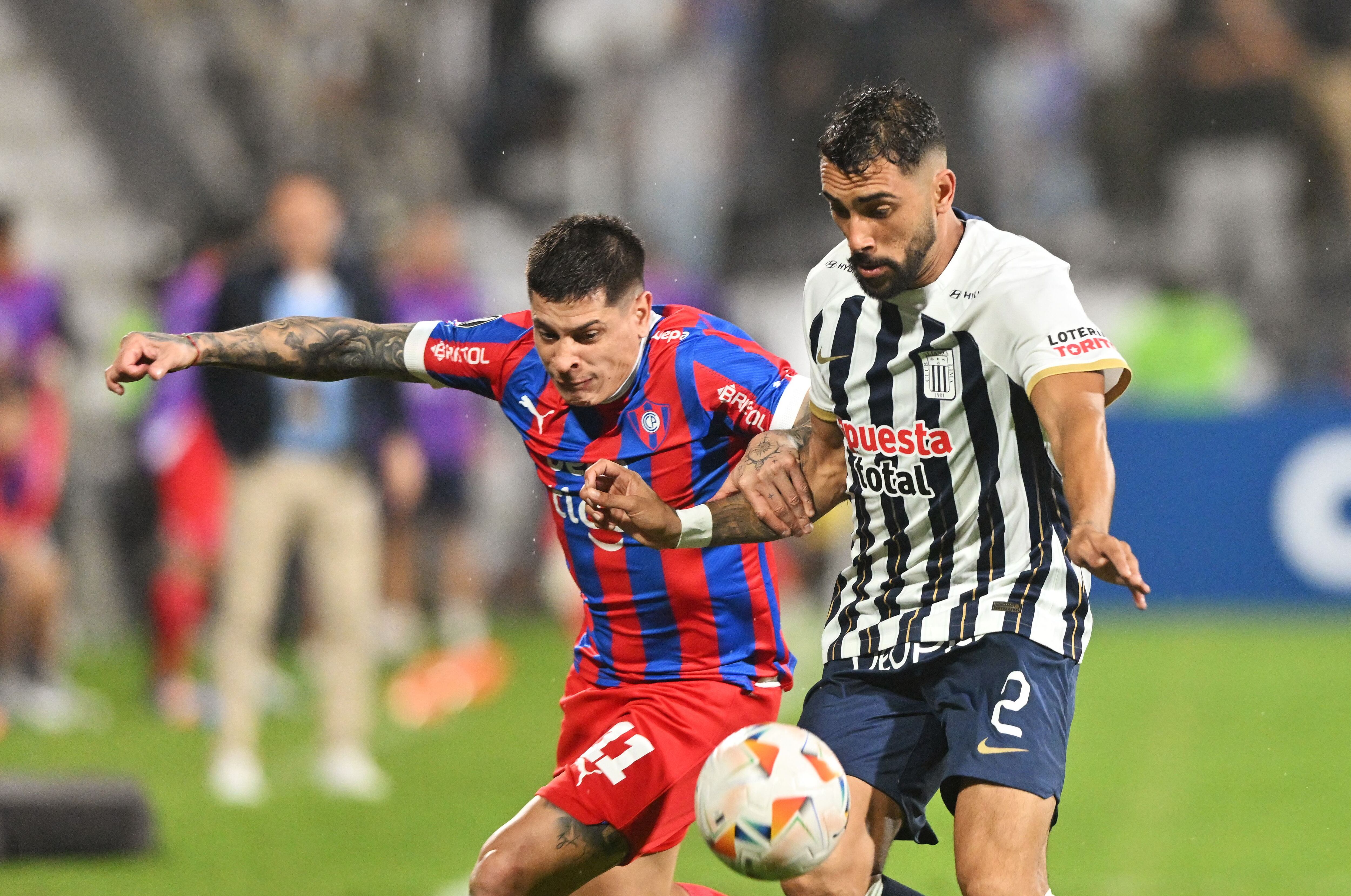 Cerro Porte�o's forward Juan Iturbe (L) and Alianza Lima's Argentine defender Juean Freytes fight for the ball during the Copa Libertadores group stage second leg football match between Peru's Alianza Lima and Paraguay's Cerro Porte�o at the Alejandro Villanueva Stadium in Lima on May 8, 2024. (Photo by CRIS BOURONCLE / AFP)