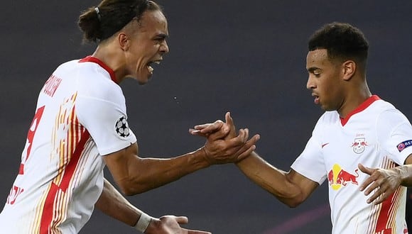 Leipzig's Danish forward Yussuf Poulsen (L) celebrates with Leipzig's US midfielder Tyler Adams their win at the end of the UEFA Champions League quarter-final football match between Leipzig and Atletico Madrid at the Jose Alvalade stadium in Lisbon on August 13, 2020. (Credit: AFP)
