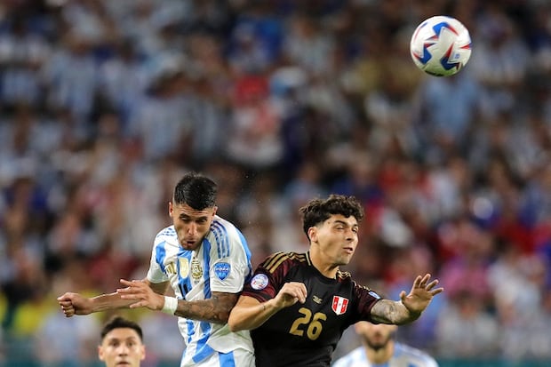 Argentina's midfielder #14 Exequiel Palacios fights for the ball with Peru's forward #26 Franco Zanelatto during the Conmebol 2024 Copa America tournament group A football match between Argentina and Peru at Hard Rock Stadium in Miami, Florida on June 29, 2024. (Photo by Chris ARJOON / AFP)