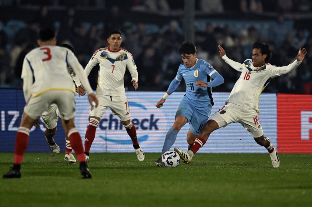 Uruguay's midfielder #11 Facundo Pellistri and Venezuela's midfielder #16 Telasco Segovia fight for the ball during the 2026 FIFA World Cup South American qualifiers football match between Uruguay and Venezuela at the Centenario stadium in Montevideo on June 10, 2025. (Photo by Eitan ABRAMOVICH / AFP)
