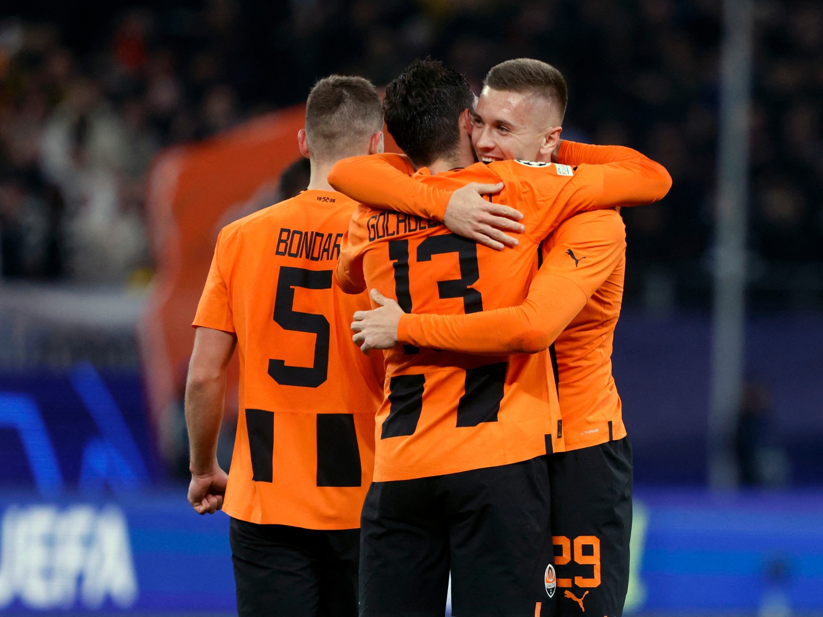 Shakhtar Donetsk's Ukrainian midfielder #29 Yegor Nazaryna (R) celebrates with Shakhtar Donetsk's Georgian defender #13 Giorgi Gocholeishvili (C) and Shakhtar Donetsk's Ukrainian defender #05 Valeriy Bondar after their team's win of the UEFA Champions League Group H football match between FC Shakhtar Donetsk and FC Barcelona in Hamburg, northern Germany on November 7, 2023. Shakhtar Donetsk won the match 1-0. | Photo by Axel Heimken / AFP