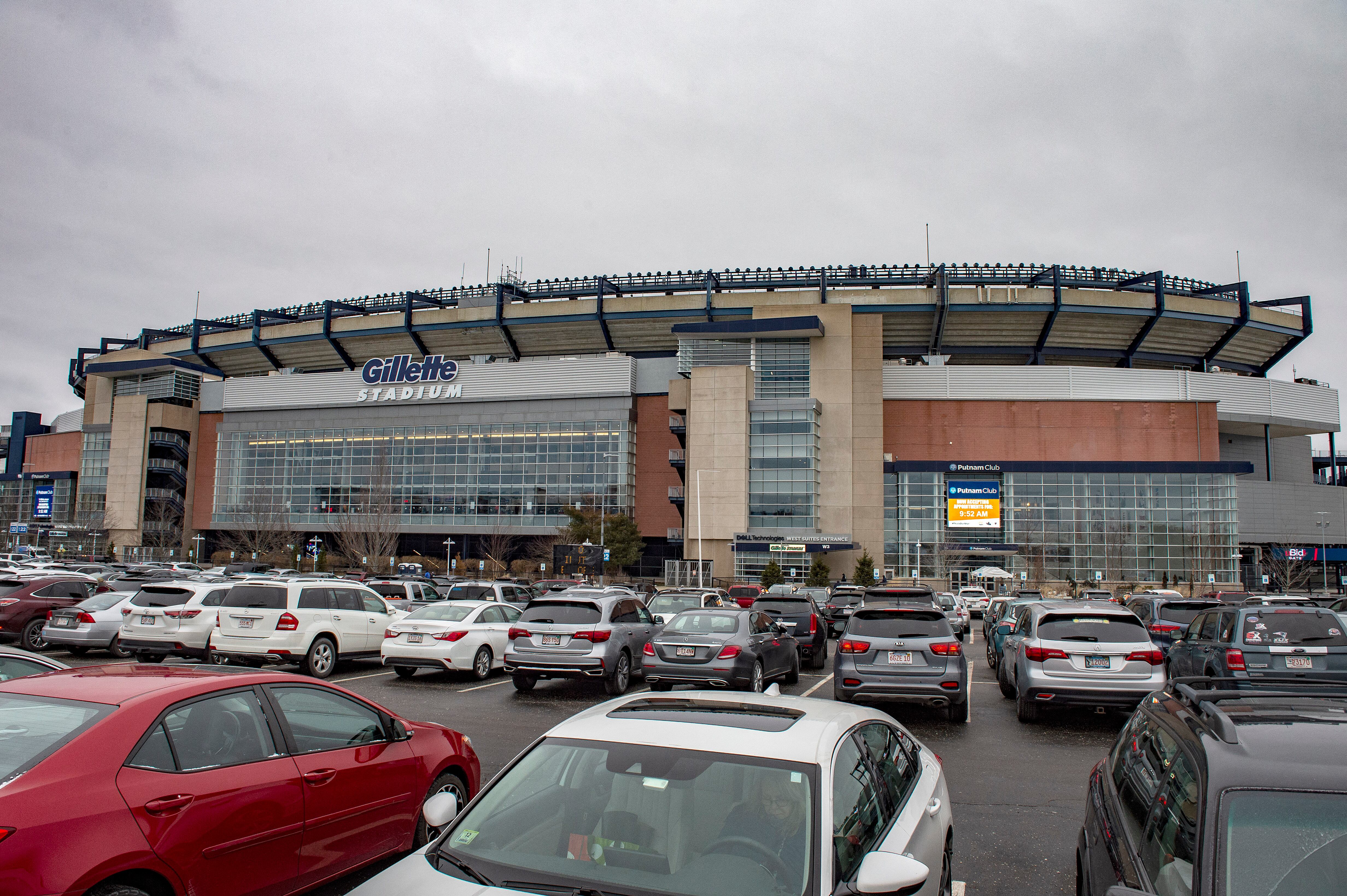 Hundreds of cars fill the car park outside the stadium as people arrive for their appointments to be inoculated against Covid-19 at Gillette Stadium in Foxborough, Massachusetts on February 1, 2021. - Mass vaccinations against Covid-19 opened to the public at Gillette Stadium as part of the beginning of "phase two" in Massachusetts with people 75 years old and older being allowed to be vaccinated. The Gillette Stadium Mass vaccination site is a partnership between the Kraft Family, CIC Health and the Commonwealth of Massachusetts. The site initially was inoculating a few hundred people a day and is now doing 2,500 people a day and working towards doing more. (Photo by Joseph Prezioso / AFP)
