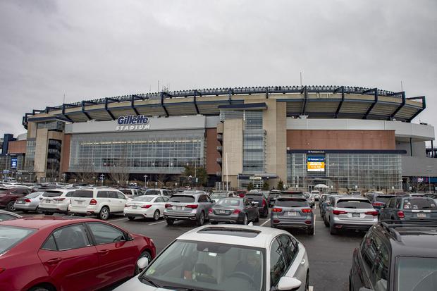Hundreds of cars fill the car park outside the stadium as people arrive for their appointments to be inoculated against Covid-19 at Gillette Stadium in Foxborough, Massachusetts on February 1, 2021. - Mass vaccinations against Covid-19 opened to the public at Gillette Stadium as part of the beginning of "phase two" in Massachusetts with people 75 years old and older being allowed to be vaccinated.  The Gillette Stadium Mass vaccination site is a partnership between the Kraft Family, CIC Health and the Commonwealth of Massachusetts.  The site initially was inoculating a few hundred people a day and is now doing 2,500 people a day and working towards doing more. (Photo by Joseph Prezioso / AFP)